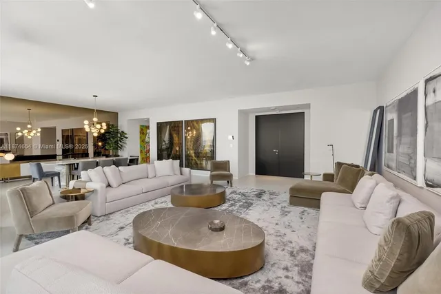 a living room with furniture and a large mirror