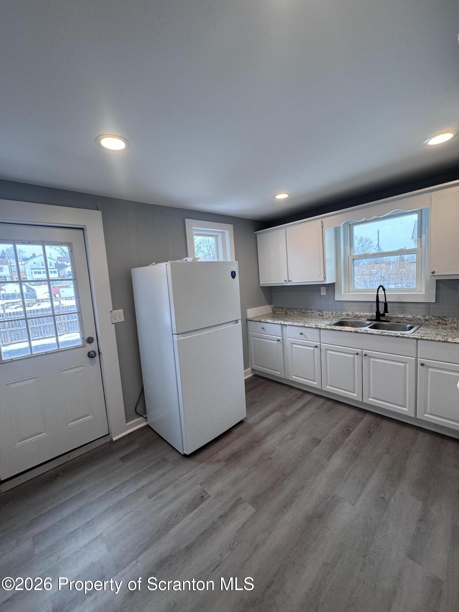 1021 Wheeler Avenue Scranton, PA 18510 - Photo 2 of 10 a kitchen with a refrigerator a sink and cabinets