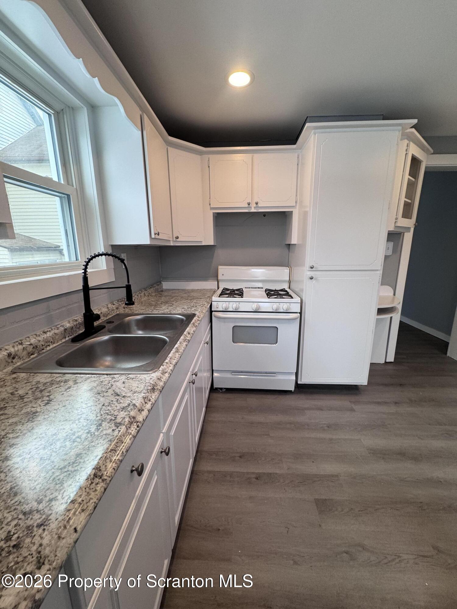 1021 Wheeler Avenue Scranton, PA 18510 - Photo 4 of 10 a kitchen with a sink a stove and cabinets