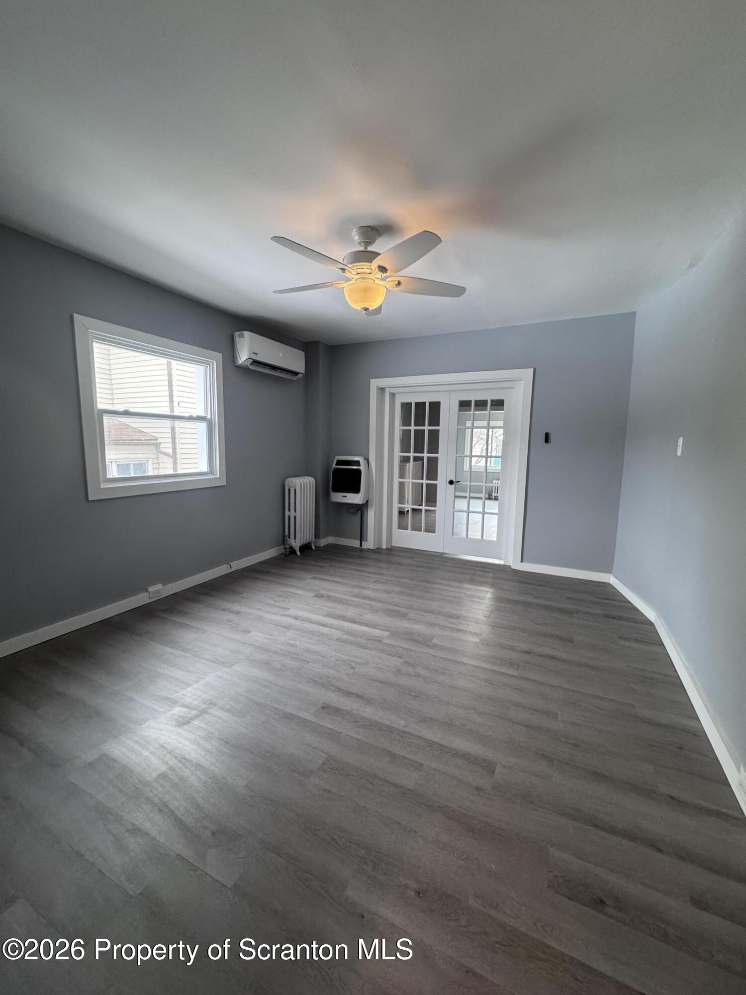 1021 Wheeler Avenue Scranton, PA 18510 - Photo 6 of 10 an empty room with wooden floor and windows