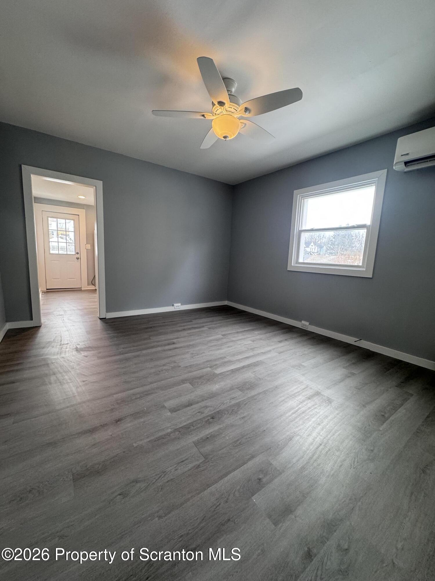 1021 Wheeler Avenue Scranton, PA 18510 - Photo 7 of 10 an empty room with wooden floor and windows