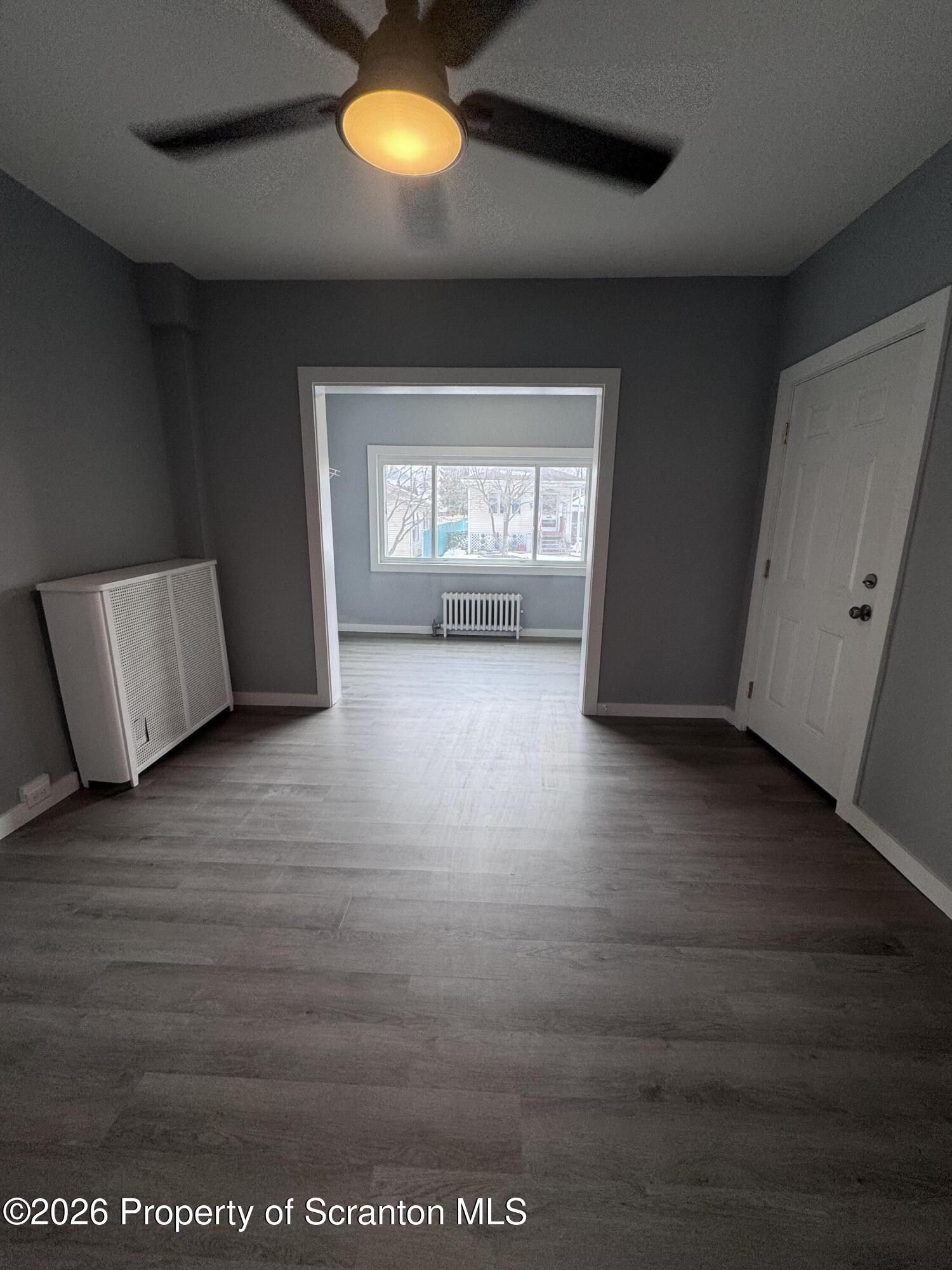 1021 Wheeler Avenue Scranton, PA 18510 - Photo 8 of 10 an empty room with wooden floor and windows