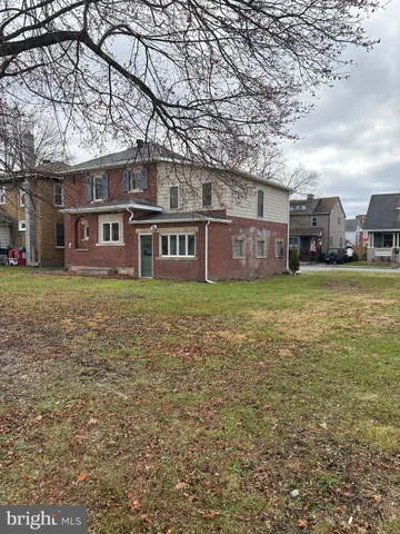 front view of a building with a yard