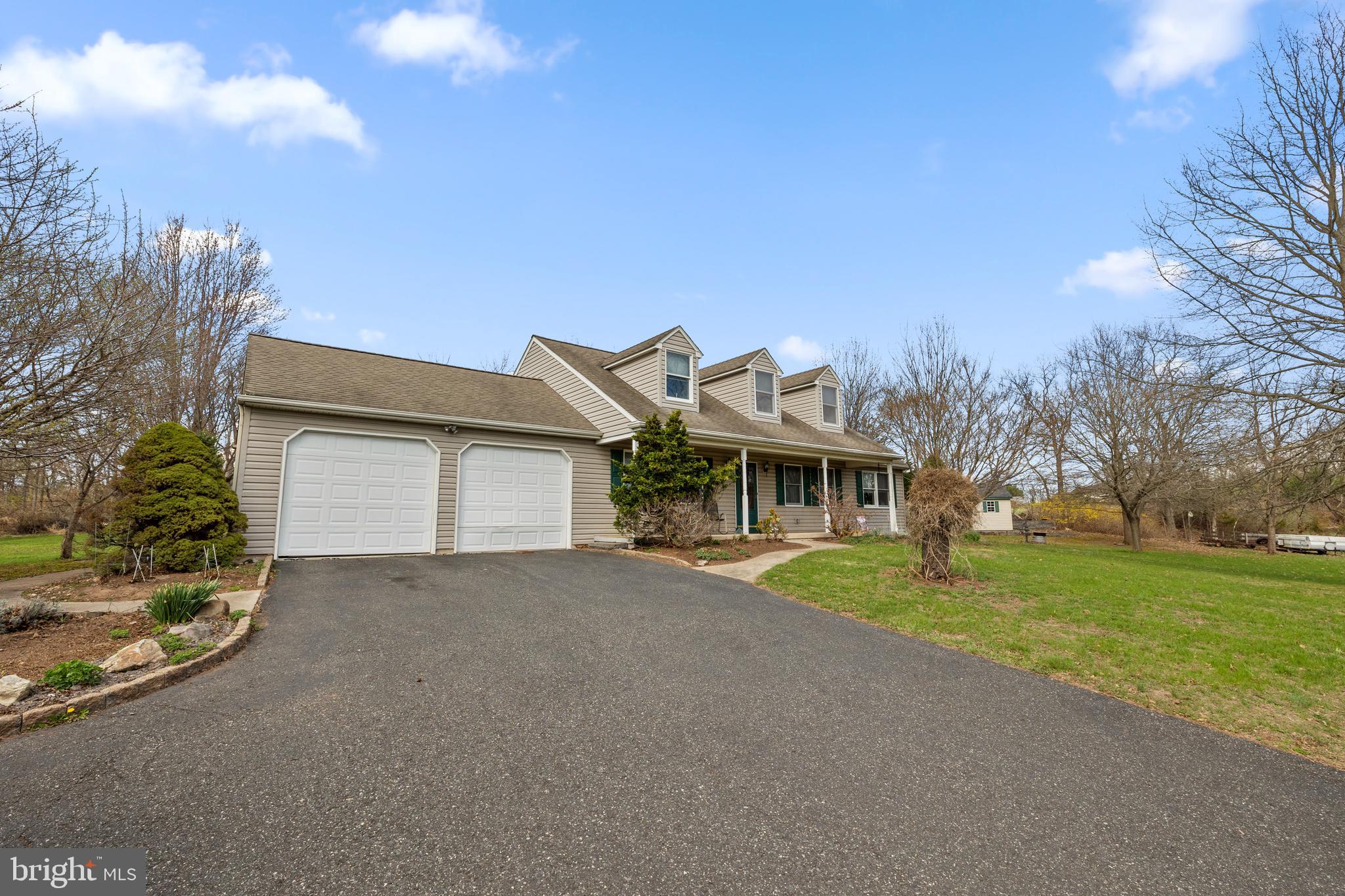 2645 West Buck Road East Greenville, PA 18041 - Photo 1 of 55 a front view of a house with a yard and garage