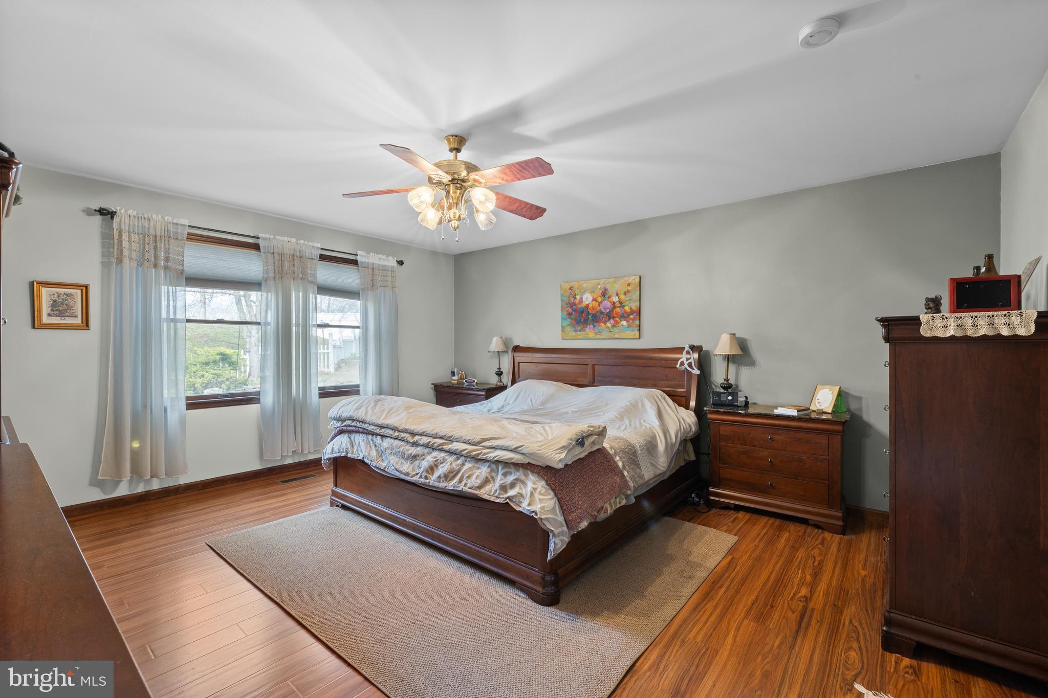 2645 West Buck Road East Greenville, PA 18041 - Photo 16 of 55 a bedroom with a large bed and a chandelier