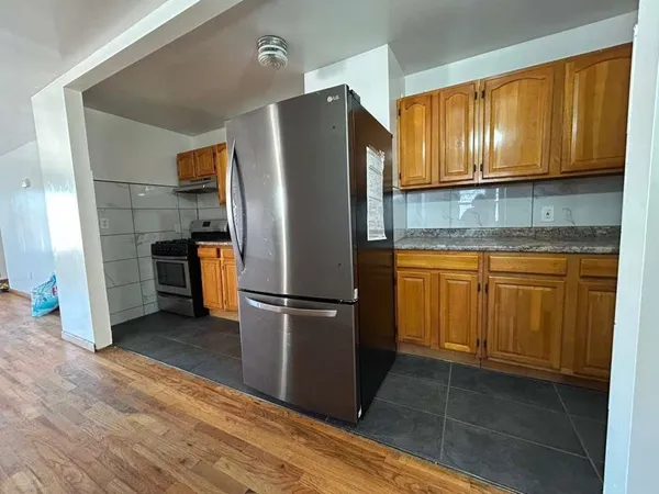 a kitchen with a refrigerator sink and cabinets