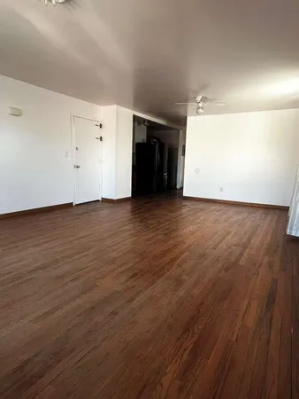 an empty room with wooden floor