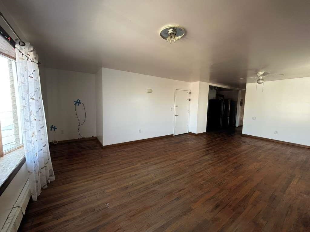 805 Secaucus Road, Unit 2 Jersey City, NJ 07307 - Photo 13 of 21 a view of an empty room with wooden floor and a window
