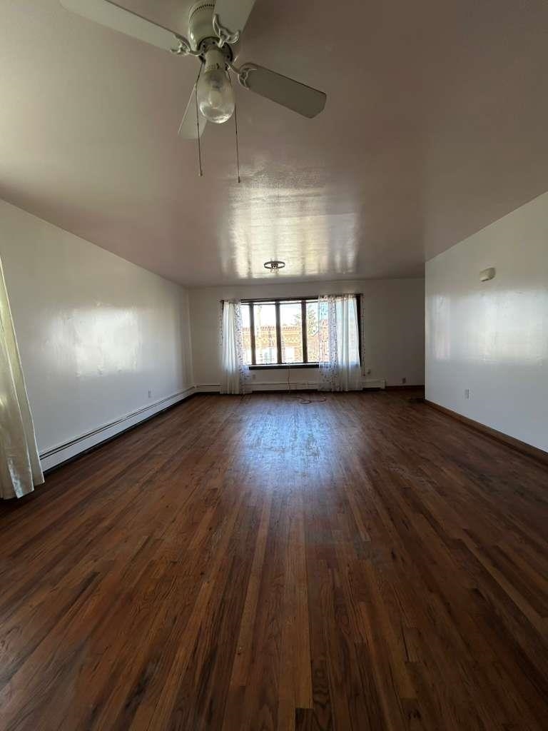 805 Secaucus Road, Unit 2 Jersey City, NJ 07307 - Photo 14 of 21 a view of an empty room with wooden floor and a window