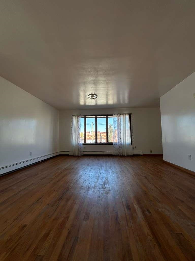 805 Secaucus Road, Unit 2 Jersey City, NJ 07307 - Photo 15 of 21 an empty room with wooden floor and windows