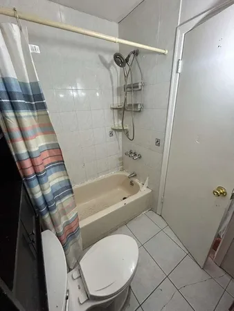 a bathroom with a toilet and a bathtub