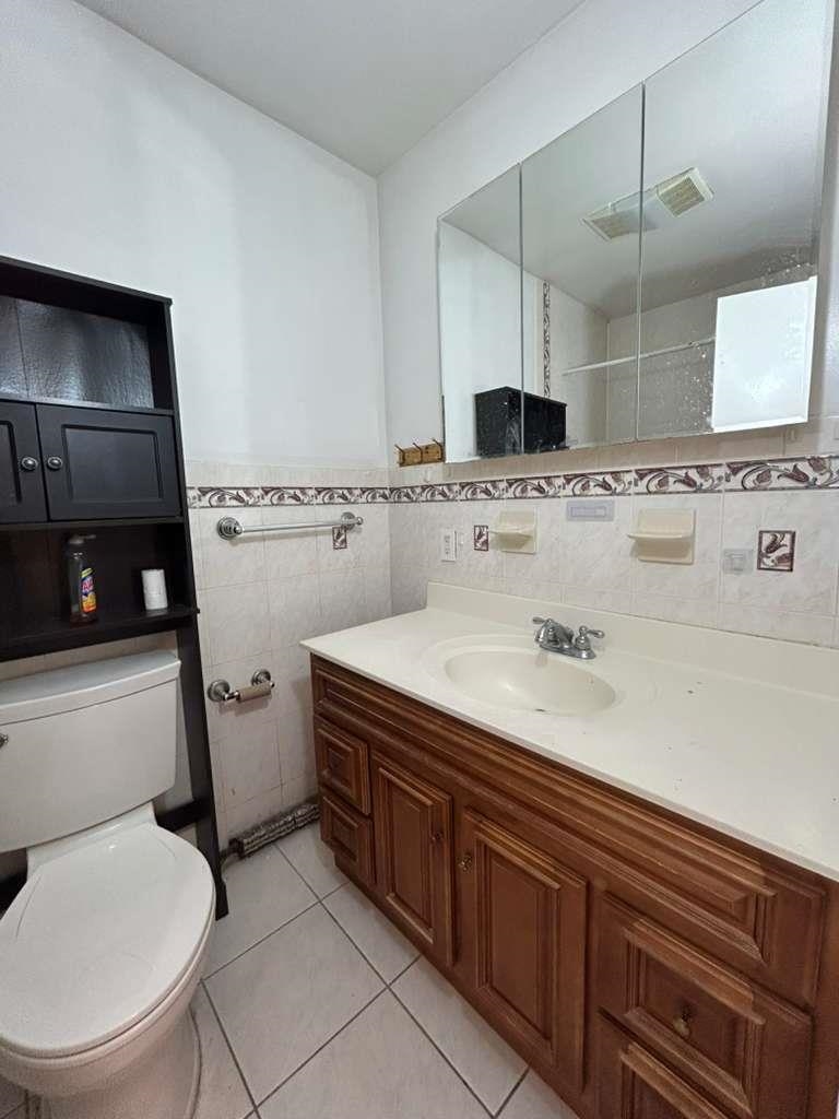 805 Secaucus Road, Unit 2 Jersey City, NJ 07307 - Photo 20 of 21 a bathroom with a sink a toilet and mirror