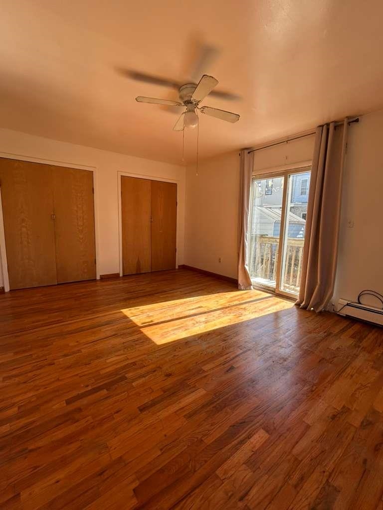 805 Secaucus Road, Unit 2 Jersey City, NJ 07307 - Photo 2 of 21 an empty room with wooden floor and windows