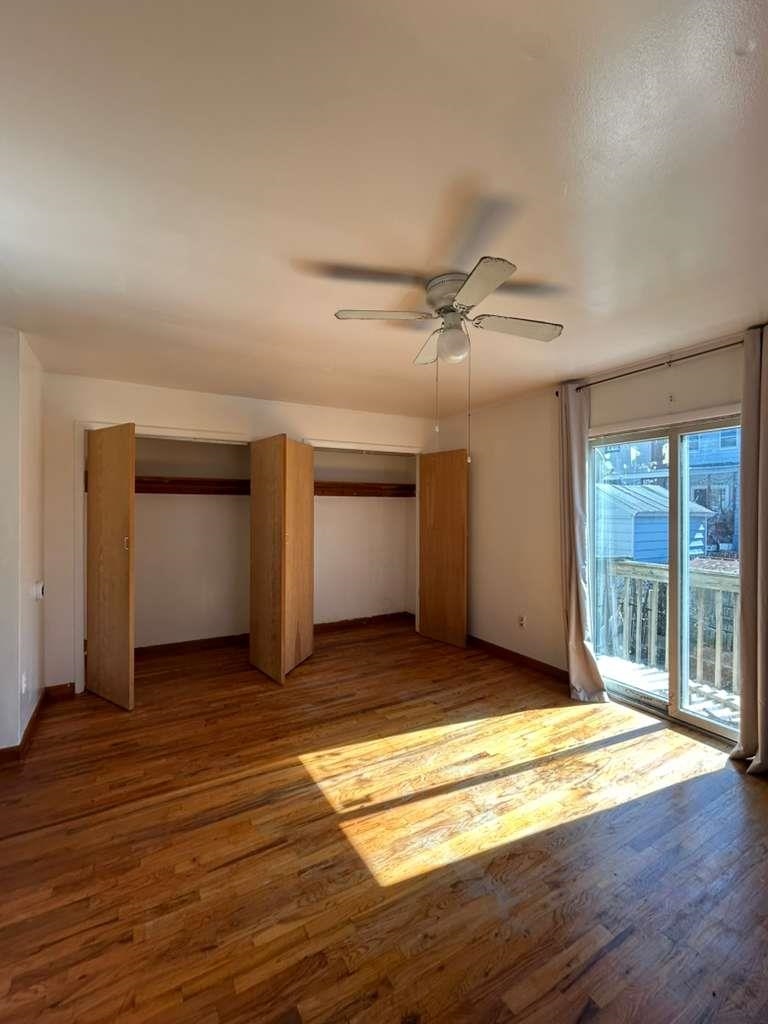 805 Secaucus Road, Unit 2 Jersey City, NJ 07307 - Photo 3 of 21 a view of an empty room with a window and wooden floor
