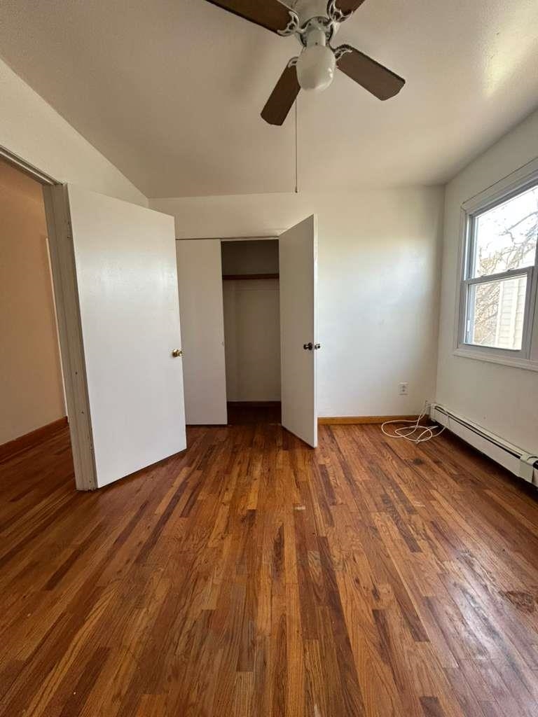 805 Secaucus Road, Unit 2 Jersey City, NJ 07307 - Photo 8 of 21 wooden floor in an empty room with a window