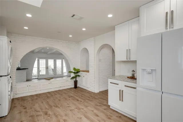 a open kitchen with white cabinets and a stove