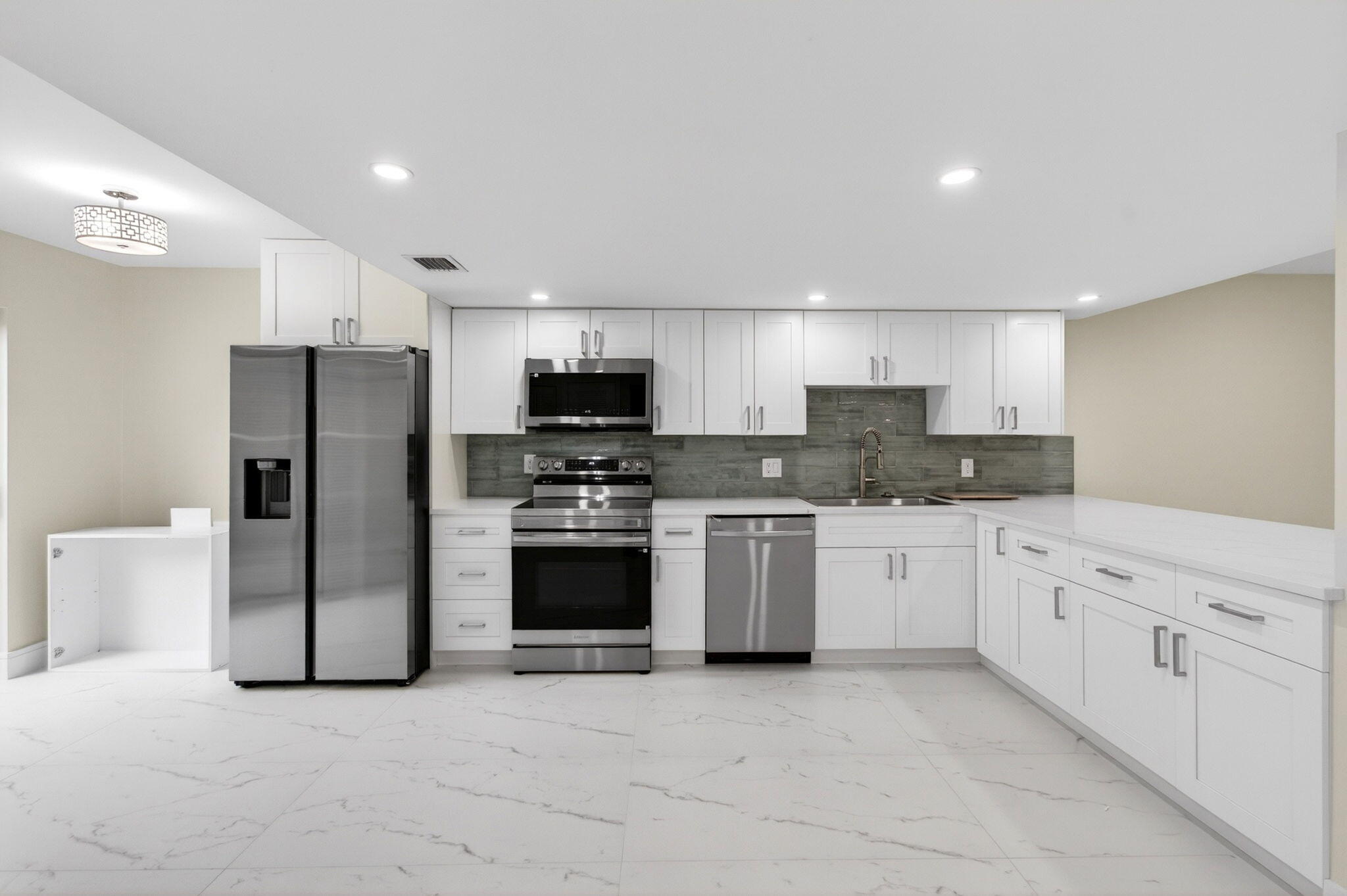 1330 Northwest 13th Street, Unit 12 Boca Raton, FL 33486 - Photo 7 of 52 a kitchen with stainless steel appliances granite countertop a refrigerator stove a sink and dishwasher