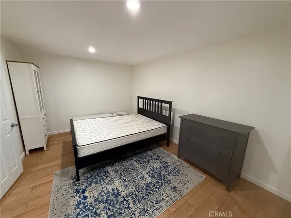 a room with a bed and wooden floor