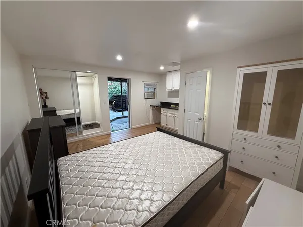 a living room with hard wood floors and furniture