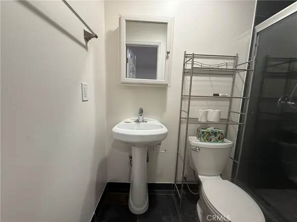 a bathroom with a sink toilet and a mirror