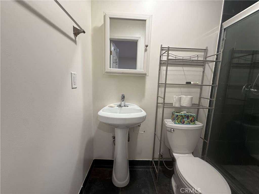 6186 Springvale Drive, Unit STUDIO Highland Park, CA 90042 - Photo 8 of 10 a bathroom with a sink toilet and a mirror