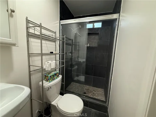 a white toilet sitting next to a bathroom