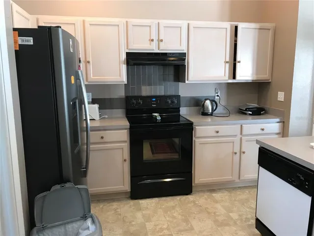 a kitchen with a stove and a refrigerator