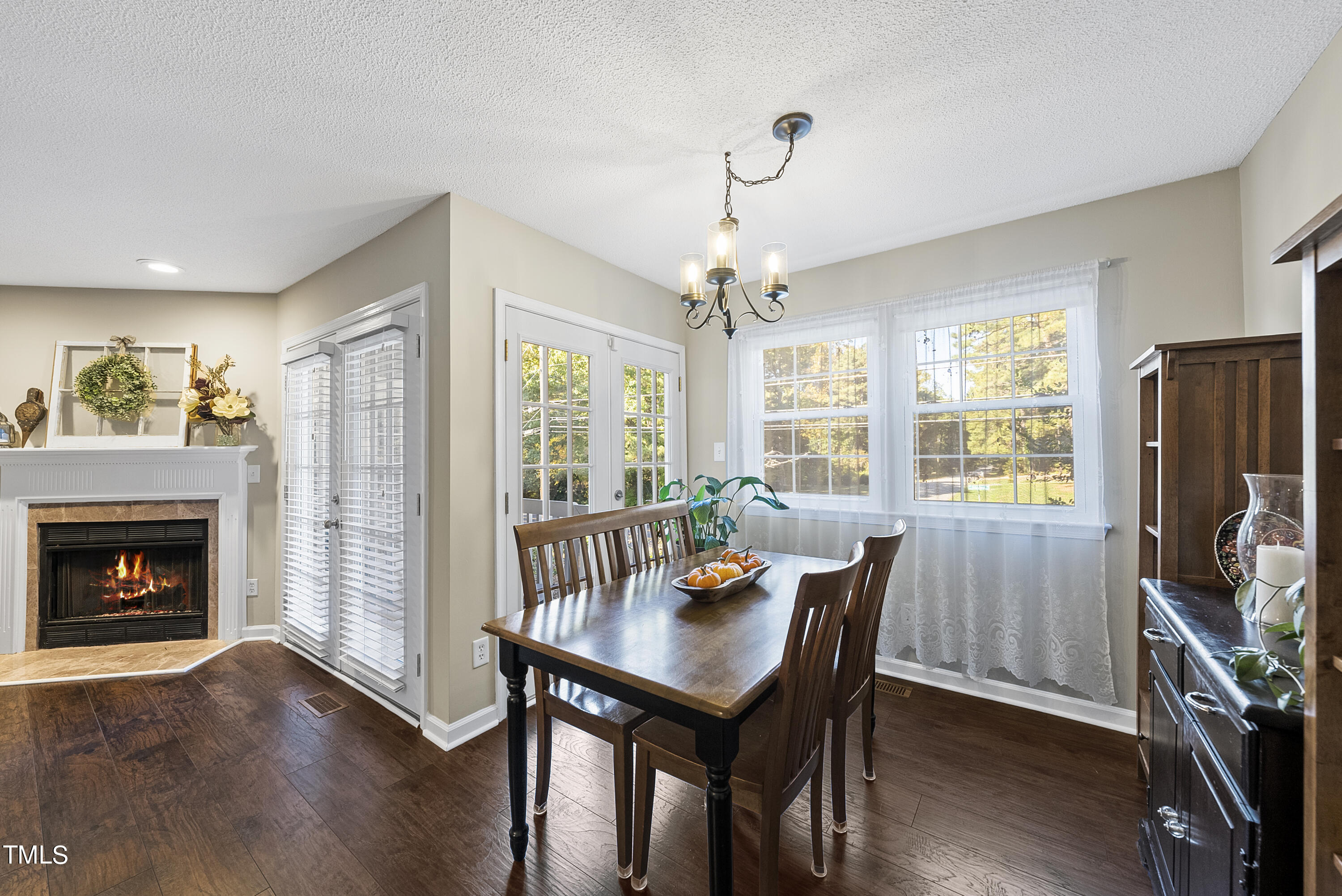 8341 Hempshire Place, Unit 101 Raleigh, NC 27613 - Photo 9 of 27 a view of a dining room with furniture window and wooden floor
