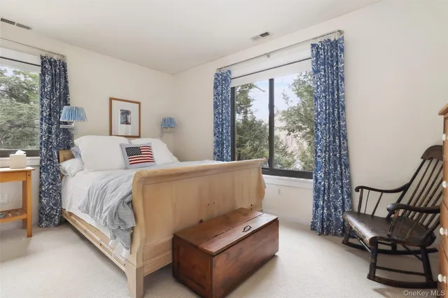 a living room with a bed and next to a window