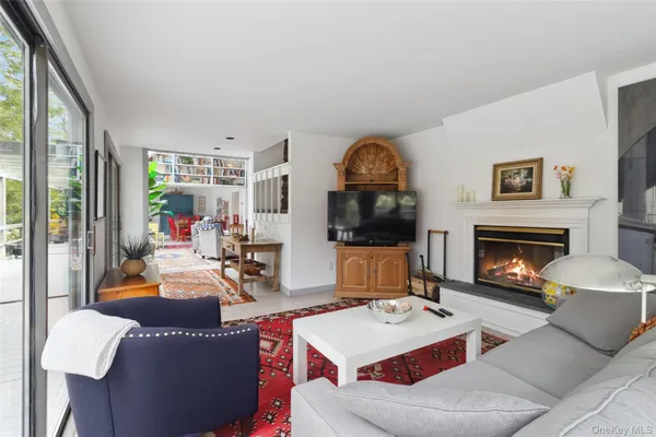 a living room with furniture a fireplace and a flat screen tv