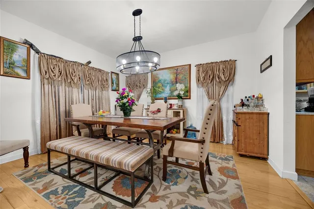 a view of a dining room with furniture wooden floor and chandelier
