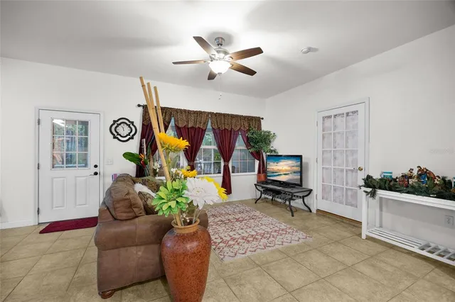 a living room with furniture and kitchen view