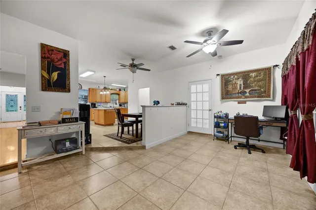 a spacious bedroom with a bed and a chandelier