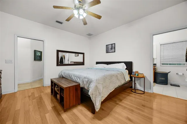a spacious bedroom with a bed and a chandelier