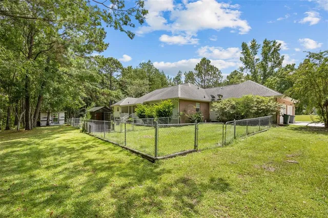 a front view of a house with a yard and trees