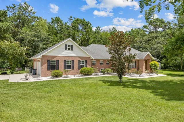 a front view of a house with garden