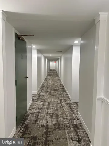 a living room with stainless steel appliances kitchen island granite countertop a refrigerator and a stove top oven