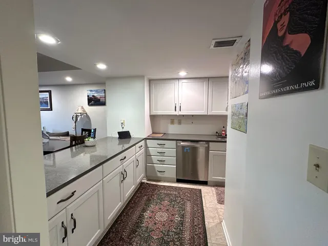 a kitchen with stainless steel appliances granite countertop a sink a stove and a refrigerator