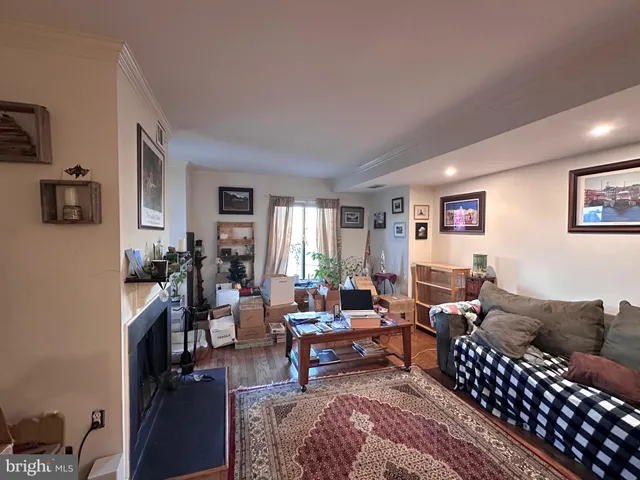 a living room with furniture wooden floor and a window