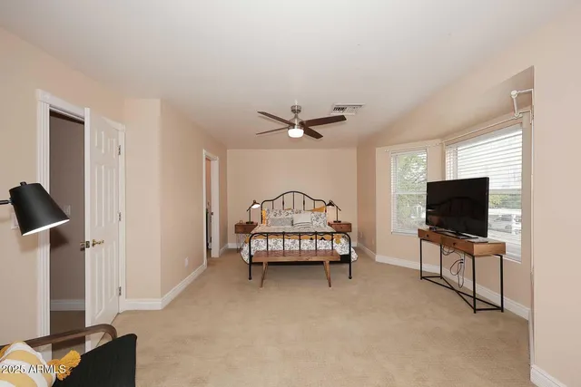a view of a hallway that has a couch and a workspace