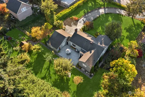 an aerial view of a house with a yard