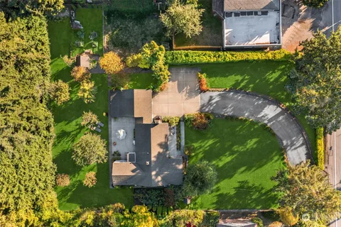 an aerial view of a house with a yard and lake view
