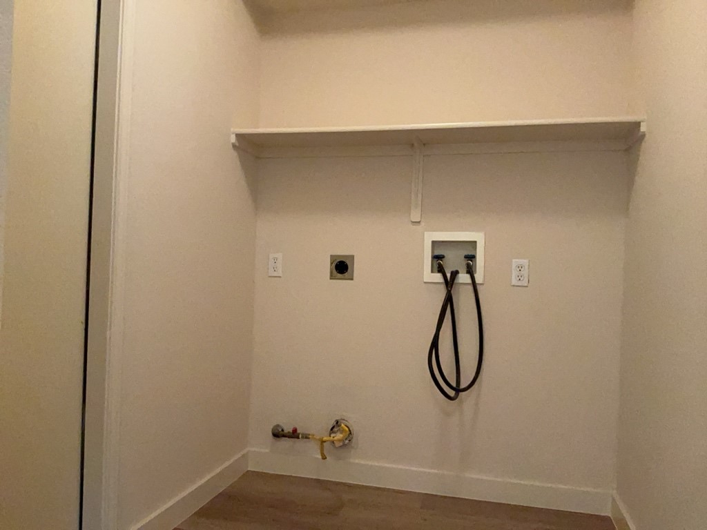 1511 Thibodeaux Drive Round Rock, TX 78664 - Photo 17 of 31 Washroom with hookup for a washing machine, wood finished floors, gas dryer hookup, and hookup for an electric dryer
