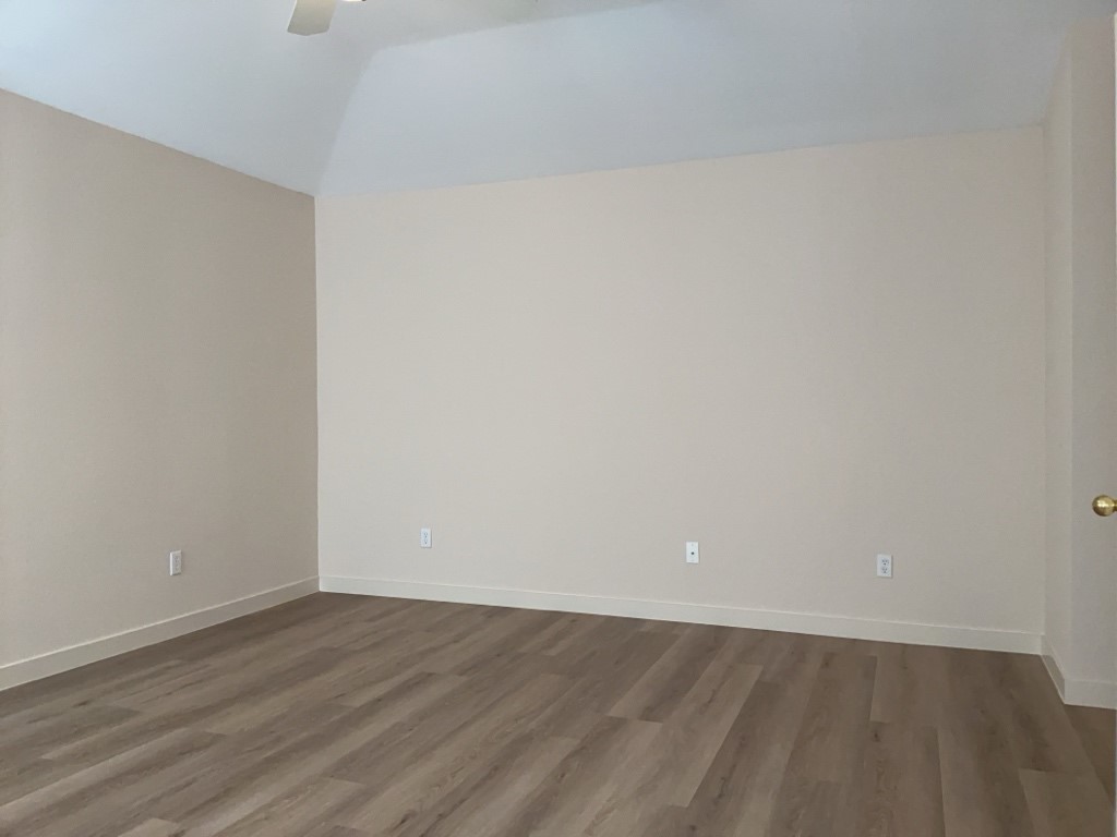 1511 Thibodeaux Drive Round Rock, TX 78664 - Photo 20 of 31 Spare room featuring dark wood finished floors, vaulted ceiling, and ceiling fan