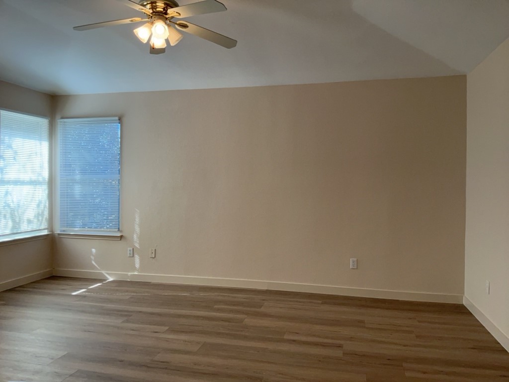 1511 Thibodeaux Drive Round Rock, TX 78664 - Photo 21 of 31 Empty room with wood finished floors, ceiling fan, and vaulted ceiling