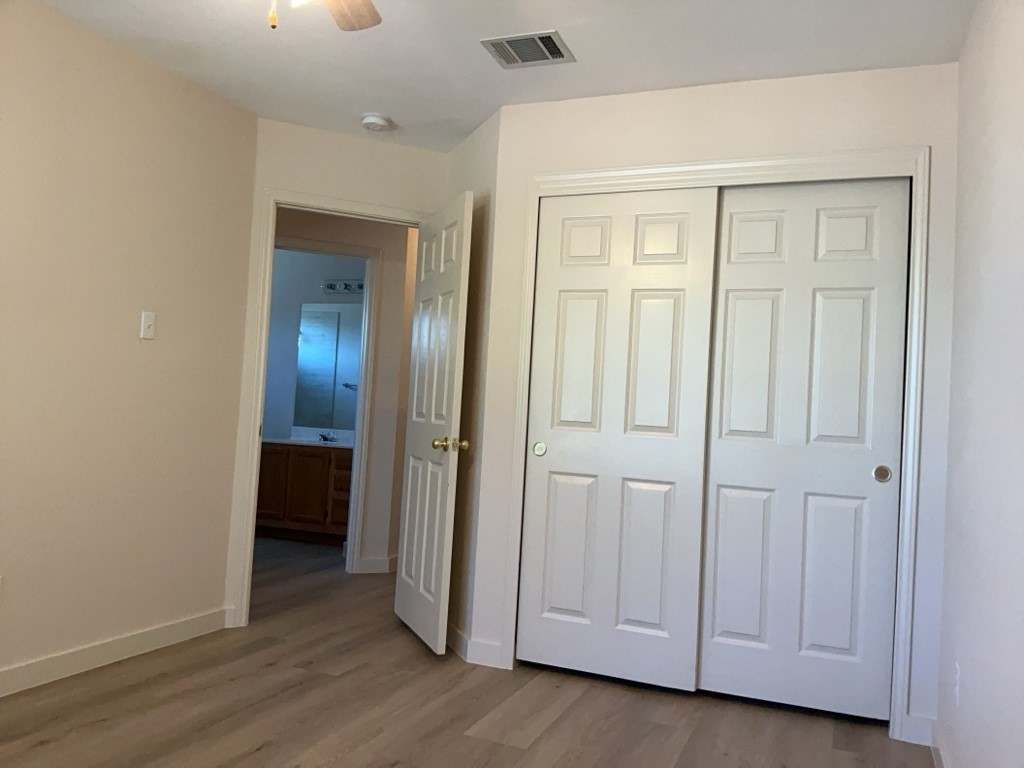 1511 Thibodeaux Drive Round Rock, TX 78664 - Photo 26 of 31 Unfurnished bedroom with light wood-style floors, a closet, and a ceiling fan