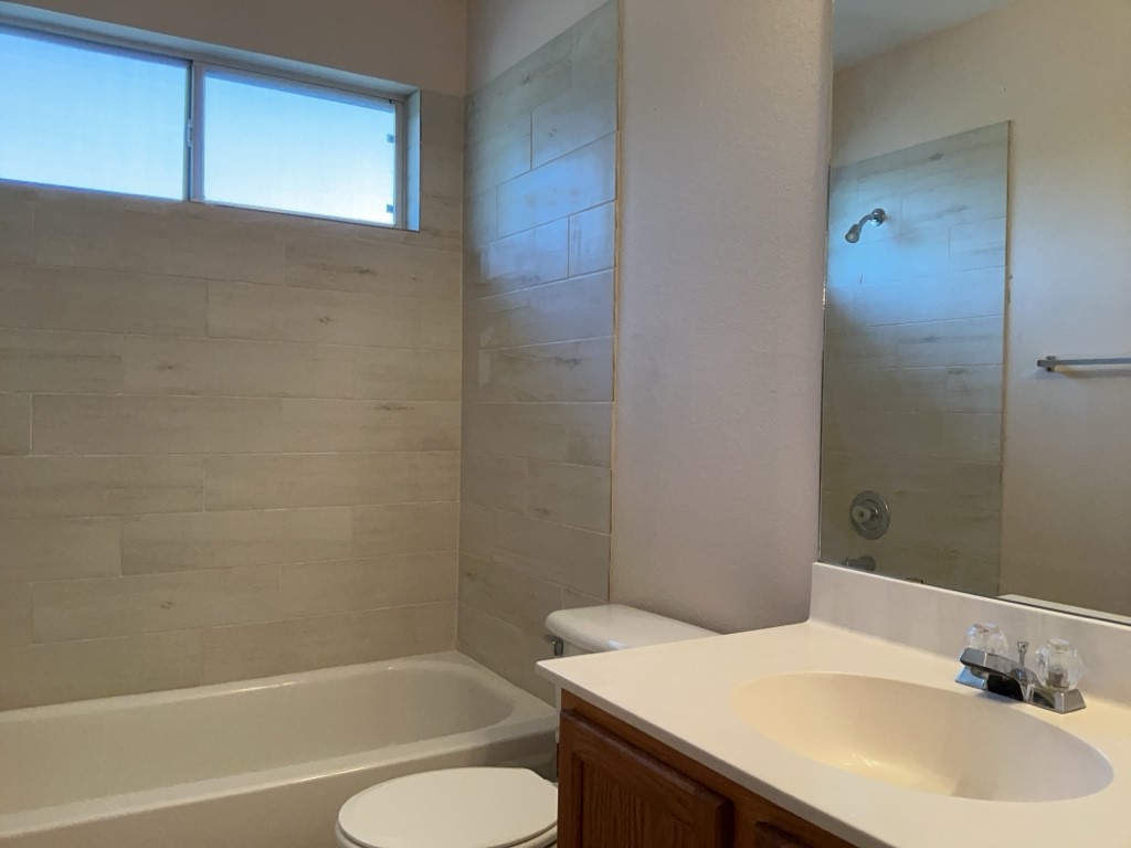 1511 Thibodeaux Drive Round Rock, TX 78664 - Photo 27 of 31 Bathroom with vanity and washtub / shower combination