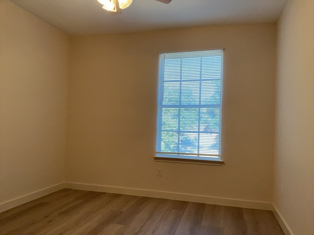 1511 Thibodeaux Drive Round Rock, TX 78664 - Photo 28 of 31 Unfurnished room featuring wood finished floors and a ceiling fan
