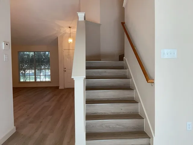 a view of entryway and hall with wooden floor