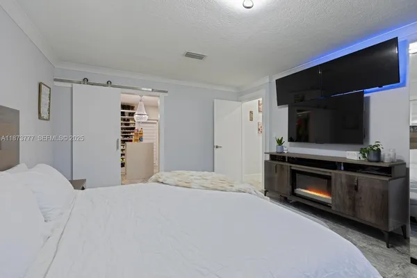 a bedroom with a bed and a television